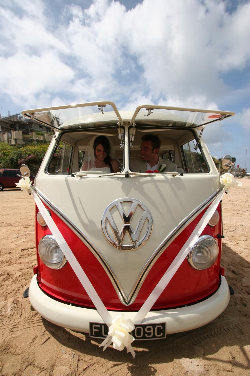Split screen VW Camper at a beach wedding